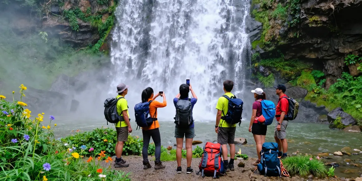 Teman-teman menikmati petualangan terjun4d di air terjun, dikelilingi alam hijau.